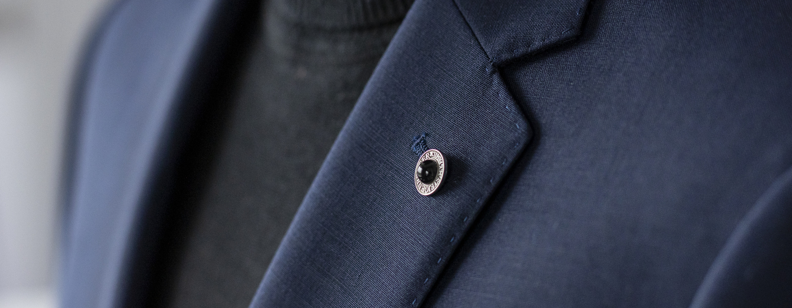 Close-up of a dark blue suit lapel.