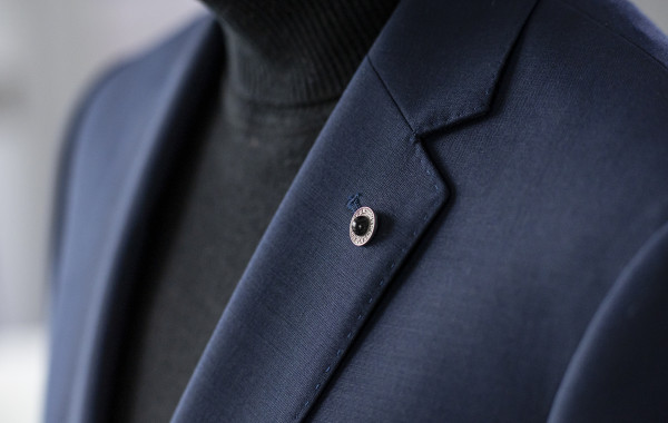 Close-up of a dark blue suit lapel.