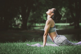 A woman doing yoga in the park.