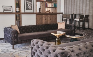 Velvet Chesterfield sofas in a contemporary hotel lounge area