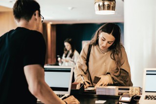 Two young people in casual clothes are working in a modern office.