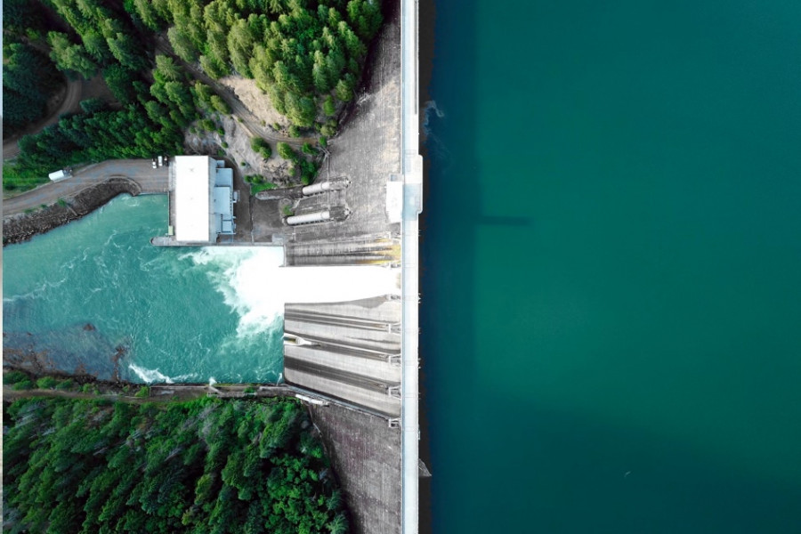 A dam in the midst of a natural setting from a bird's eye view.