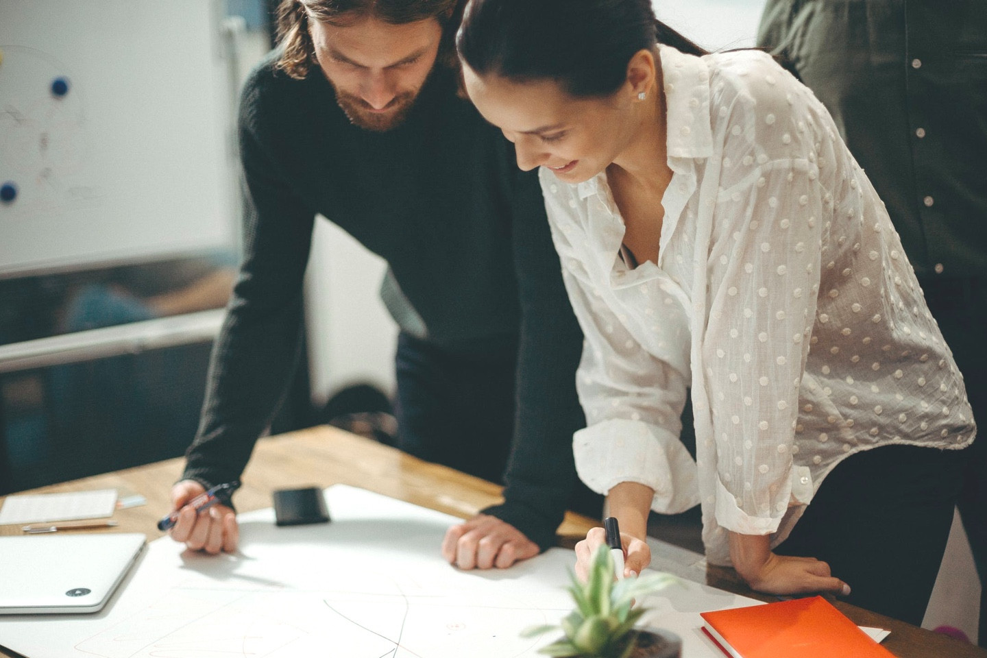 Two employees poring over a sketch.